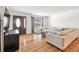 Bright living room featuring wood floors, neutral paint, and a large comfortable couch at 5005 W Evelyn Dr, Tampa, FL 33609