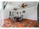 Covered patio offers outdoor seating, ceiling fans, and brick pavers, perfect for entertaining at 5005 W Evelyn Dr, Tampa, FL 33609