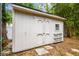 Storage shed featuring a white exterior and double doors at 5005 W Evelyn Dr, Tampa, FL 33609
