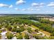 Expansive aerial view of a residential area with trees, water and a clear blue sky at 509 Falmouth St, Temple Terrace, FL 33617