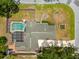 Overhead view of a home featuring a screened pool area, spacious yard, and a concrete driveway at 509 Falmouth St, Temple Terrace, FL 33617