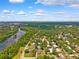 Scenic aerial shot of a lush, green neighborhood near a winding river under a blue sky at 509 Falmouth St, Temple Terrace, FL 33617