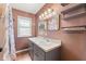 Bathroom featuring a vanity with storage and shower with floral curtain at 509 Falmouth St, Temple Terrace, FL 33617