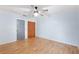 Cozy bedroom features laminate floors, closet space, and a ceiling fan at 509 Falmouth St, Temple Terrace, FL 33617