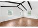 Bright empty room with wood floors, white trim, and several windows at 509 Falmouth St, Temple Terrace, FL 33617