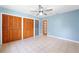 Bedroom with tile floors, large closet, and light blue walls at 509 Falmouth St, Temple Terrace, FL 33617