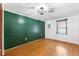 A large empty room with hardwood floors and a bright green wall at 509 Falmouth St, Temple Terrace, FL 33617