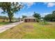 Charming brick home featuring a well-maintained front yard and a long driveway at 509 Falmouth St, Temple Terrace, FL 33617