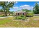 Charming front yard of a brick home with a garden in front at 509 Falmouth St, Temple Terrace, FL 33617