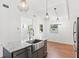 Bright kitchen features white walls, modern lighting and a stainless steel farmhouse sink at 509 Falmouth St, Temple Terrace, FL 33617