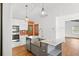 Updated kitchen with white cabinets, stainless steel appliances, marble countertops, and a farmhouse sink at 509 Falmouth St, Temple Terrace, FL 33617