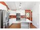 Bright kitchen with white cabinets, stainless steel appliances, marble countertops, and modern pendant lighting at 509 Falmouth St, Temple Terrace, FL 33617
