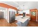 Bright kitchen featuring white cabinets, stainless steel appliances, a marble island, and a rustic door at 509 Falmouth St, Temple Terrace, FL 33617
