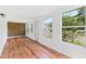 Bright room featuring laminate wood flooring and large windows overlooking the yard at 509 Falmouth St, Temple Terrace, FL 33617