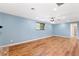 Living room with wood floors, recessed lighting, and light blue walls at 509 Falmouth St, Temple Terrace, FL 33617