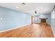 Spacious living room with hardwood floors, blue walls, a fireplace, and ceiling fan at 509 Falmouth St, Temple Terrace, FL 33617
