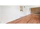 Bright room featuring laminate wood flooring, a door with a diamond pattern and a wall of brick at 509 Falmouth St, Temple Terrace, FL 33617
