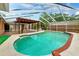 Screened-in pool featuring a pergola and deck area at 509 Falmouth St, Temple Terrace, FL 33617