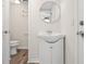 Bathroom featuring a sink and toilet, with vinyl floors at 5122 Chet Dr, New Port Richey, FL 34652