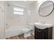 Bathroom featuring a shower-tub combo with tiled walls and a vanity at 5122 Chet Dr, New Port Richey, FL 34652