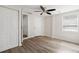 Bright bedroom featuring a ceiling fan, wood floors, and a closet at 5122 Chet Dr, New Port Richey, FL 34652
