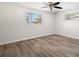 Bright bedroom with light-colored walls, wood-look floors, a ceiling fan and two windows at 5122 Chet Dr, New Port Richey, FL 34652