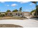 Charming single-story home featuring a well-manicured lawn and a freshly painted exterior at 5122 Chet Dr, New Port Richey, FL 34652