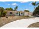 Charming single-story home featuring a well-manicured lawn and a freshly painted exterior at 5122 Chet Dr, New Port Richey, FL 34652