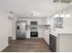 Modern kitchen featuring stainless steel appliances, white cabinetry, and stylish backsplash at 5122 Chet Dr, New Port Richey, FL 34652