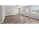 Bright living room with wood-look floors, a new coat of paint, and updated windows at 5122 Chet Dr, New Port Richey, FL 34652