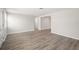 Bright, spacious living room with modern wood-look flooring and fresh paint at 5122 Chet Dr, New Port Richey, FL 34652