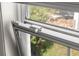 View of home's window with white trim and screens showcasing the outdoor scenery at 5122 Chet Dr, New Port Richey, FL 34652
