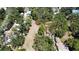 A high angle shows a vacant lot surrounded by mature trees and a partial building structure at 5680 77Th N Ave, Pinellas Park, FL 33781