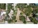 An aerial view shows a property with mature trees and landscaping in a residential neighborhood at 5680 77Th N Ave, Pinellas Park, FL 33781
