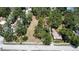 Aerial view of vacant lot with scattered trees, showing proximity to street and neighborhood at 5680 77Th N Ave, Pinellas Park, FL 33781