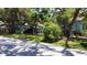 Exterior view of the residence reveals mature trees and lush landscaping around the property at 5680 77Th N Ave, Pinellas Park, FL 33781