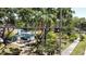 Exterior view of the house with a beautiful green lawn, sidewalk, and mature trees at 5680 77Th N Ave, Pinellas Park, FL 33781