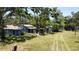 Exterior view of a blue single-story home, with a small structure in the front yard at 5680 77Th N Ave, Pinellas Park, FL 33781