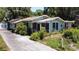 Street view of a well-maintained one-story home with a cozy porch and landscaped front yard at 5680 77Th N Ave, Pinellas Park, FL 33781