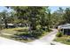 A residential neighborhood showcases a house with mature trees and a charming landscape at 5680 77Th N Ave, Pinellas Park, FL 33781