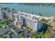 Aerial view of low rise condo building with parking and tropical landscaping at 5701 Bahia Del Mar Cir # 108, St Petersburg, FL 33715