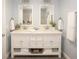 Bright bathroom featuring double sink vanity, quartz counters, and fresh white cabinets at 5701 Bahia Del Mar Cir # 108, St Petersburg, FL 33715