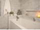 Close up view of a modern soaking tub, shower and marble-look tiled walls at 5701 Bahia Del Mar Cir # 108, St Petersburg, FL 33715