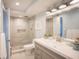 Modern bathroom showcasing a tiled shower, contemporary vanity and a toilet at 5701 Bahia Del Mar Cir # 108, St Petersburg, FL 33715