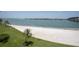Lush landscaping and palm trees line the beach with views of the bay at 5701 Bahia Del Mar Cir # 108, St Petersburg, FL 33715