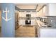 Modern kitchen featuring stainless steel appliances, white cabinets, and beautiful tile backsplash at 5701 Bahia Del Mar Cir # 108, St Petersburg, FL 33715