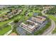 Aerial view of residences bordering a golf course, ponds, and winding streets at 6100 Gulfport S Blvd # 415, Gulfport, FL 33707