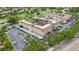 Aerial view of a residential building and parking lot in a golf course community with a pond at 6100 Gulfport S Blvd # 415, Gulfport, FL 33707