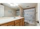 Cozy bathroom with a wooden vanity and a decorative shower curtain at 6100 Gulfport S Blvd # 415, Gulfport, FL 33707