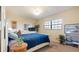 Bright bedroom with a large window, blue quilt, and a quaint white headboard dresser at 6100 Gulfport S Blvd # 415, Gulfport, FL 33707